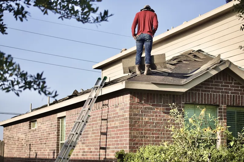 Professional roofer working on a residential roof in Barnum Island